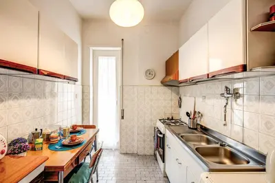 a kitchen with a sink and a table in it at BlueClassicHome in Rome
