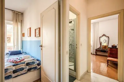 a bedroom with a bed and a hallway with a mirror at BlueClassicHome in Rome