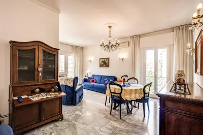 a living room with a table and a blue couch at BlueClassicHome in Rome