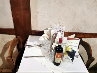 a white table with a bottle of wine and glasses at Hotel Valentino Palace in Rome