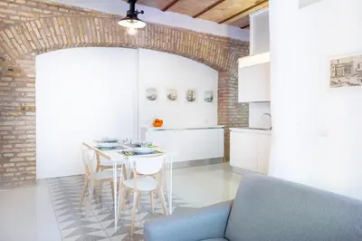 a kitchen and dining room with a table and chairs at Lilli Vatican White Domus in Rome