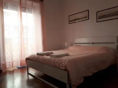 a bedroom with a bed and a window at A casa di Robi in Rome