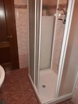 a shower with a glass door in a bathroom at A casa di Robi in Rome