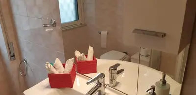 a bathroom with a sink with two baskets on it at A casa di Robi in Rome