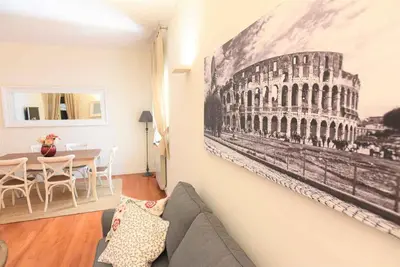 a living room with a painting of the coliseum at Romantic Flat near Metro Flaminio in Rome