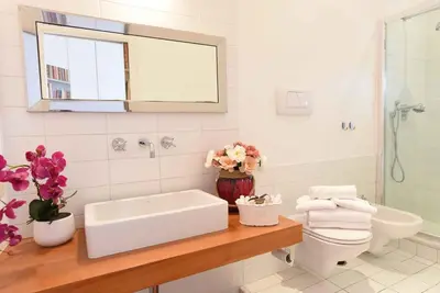 a white bathroom with a sink and a toilet at Romantic Flat near Metro Flaminio in Rome