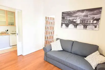 a living room with a couch and a book shelf at Romantic Flat near Metro Flaminio in Rome