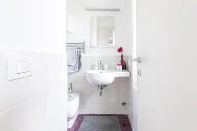 a white bathroom with a sink and a toilet at Lambertone, cozy flat in Rome, Aurelio Vatican in Rome