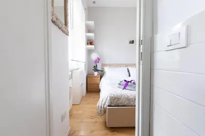 a small bedroom with a bed and a mirror at Lambertone, cozy flat in Rome, Aurelio Vatican in Rome