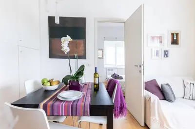 a living room with a table and a couch at Lambertone, cozy flat in Rome, Aurelio Vatican in Rome