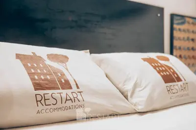 a pillow on a table with a sign for a restaurant at Restart Accommodations Balestra in Rome