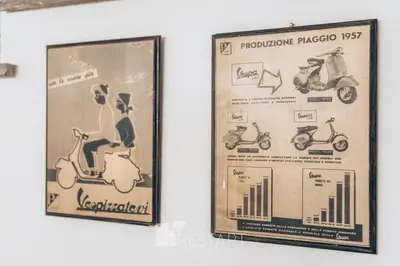 two posters on a wall with a scooter at Restart Accommodations Balestra in Rome