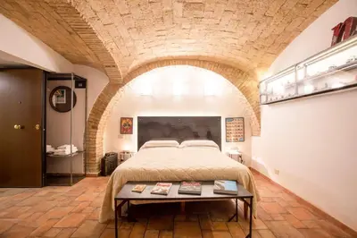 a bedroom with a bed and a table in a room at Restart Accommodations Balestra in Rome