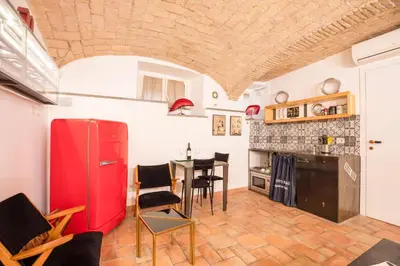 a kitchen with a red refrigerator and a table at Restart Accommodations Balestra in Rome