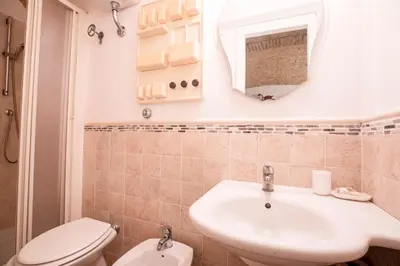 a bathroom with a sink and a toilet and a mirror at Restart Accommodations Balestra in Rome