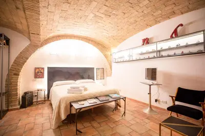 a bedroom with a large bed in a brick wall at Restart Accommodations Balestra in Rome