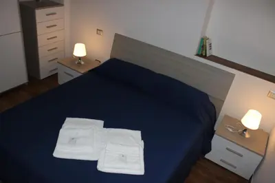 a bedroom with a blue bed with two towels on it at Locazione Turistica 