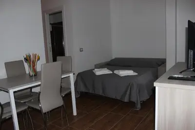 a small room with a bed and a table and a desk at Locazione Turistica 