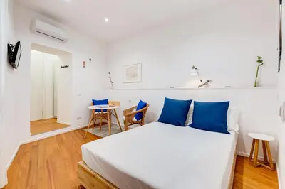 a bedroom with a bed and a table and chairs at Lovely and modern nest near the Colosseum in Rome
