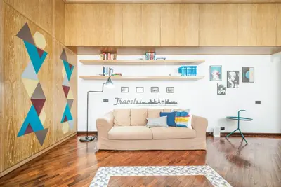a living room with a couch and a wall at Rome As You Feel - Baccina 95 Forum Apartment in Rome
