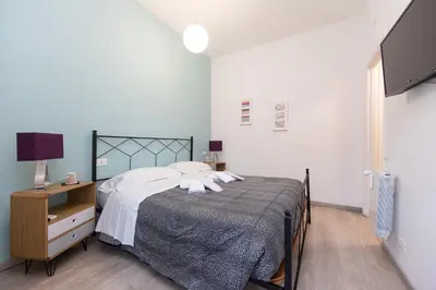 a bedroom with a bed and a desk and a television at L'Imperiale RomaTrastevere in Rome