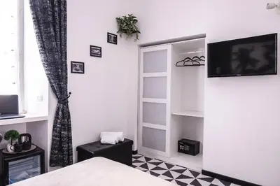 a bedroom with a bed and a tv on a wall at Roma Centrale Fidelis in Rome