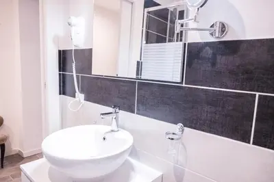 a bathroom with a white sink and a mirror at Roma Centrale Fidelis in Rome