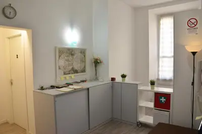 a kitchen with white cabinets and a counter at Roma Centrale Fidelis in Rome
