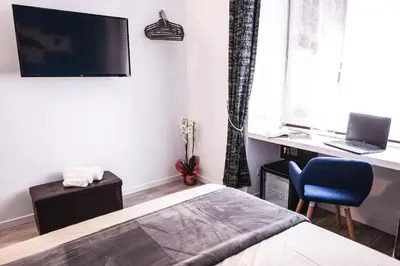a bedroom with a bed and a desk with a laptop at Roma Centrale Fidelis in Rome
