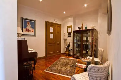a living room with a piano and a table at B&B Roma Appia Davila25 in Rome