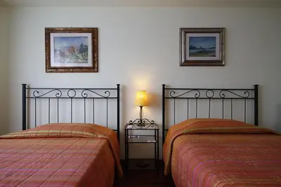 two beds sitting next to each other in a bedroom at B&B Roma Appia Davila25 in Rome