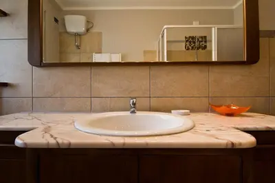 a bathroom counter with a sink and a mirror at B&B Roma Appia Davila25 in Rome