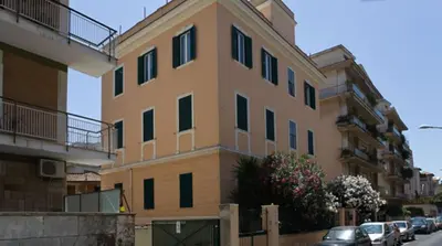 a tall building with cars parked in front of it at B&B Roma Appia Davila25 in Rome