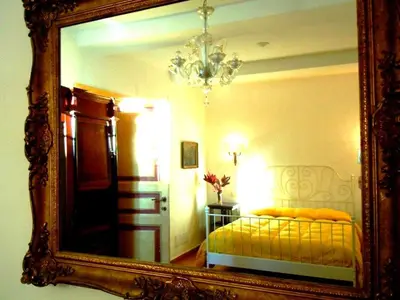 a mirror reflection of a bedroom with a bed in it at Via Giulia Apartment in Rome