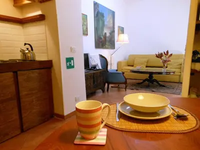 a kitchen with a table and chairs in a room at Via Giulia Apartment in Rome