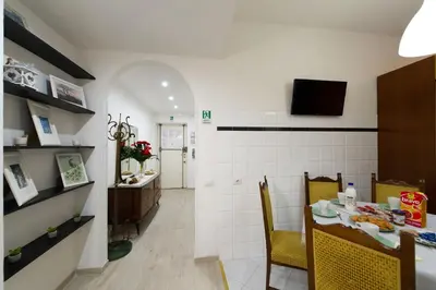 a kitchen and dining room with a table and chairs at House Bonifacio in Rome