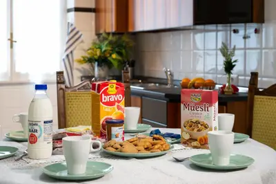 a table topped with plates of food and milk at House Bonifacio in Rome