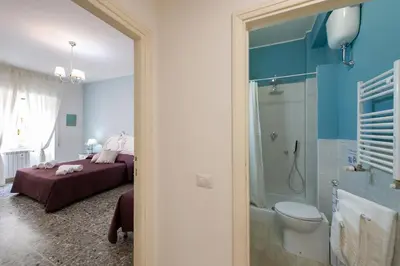 a bedroom with a bed and a shower and a toilet at House Bonifacio in Rome