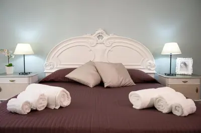 a bedroom with a large bed with towels on it at House Bonifacio in Rome