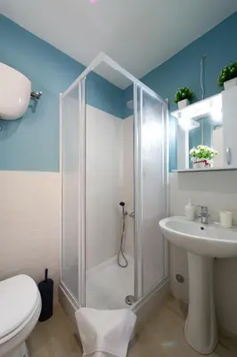 a bathroom with a shower and a toilet and a sink at House Bonifacio in Rome