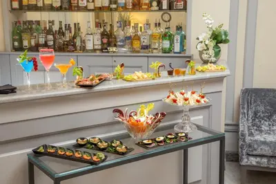 a bar with appetizers and drinks on a counter at Hotel Della Conciliazione in Rome