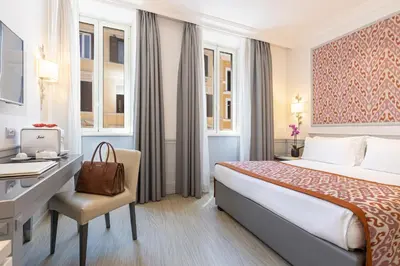 a hotel room with a bed and a desk and a computer at Hotel Della Conciliazione in Rome