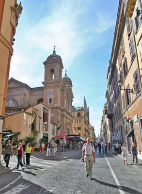 a group of people walking down a city street with a church at Amazing panoramic artist's loft Spanish Steps in Rome