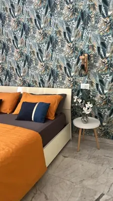 a bedroom with a bed and a blue and white wallpaper at Guest House Esty in Rome