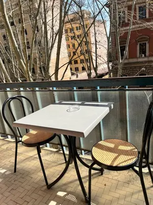 a white table and two chairs on a balcony at Guest House Esty in Rome