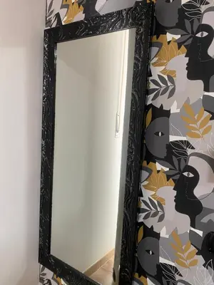 a mirror in a black frame with a black cat patterned wall at Guest House Esty in Rome