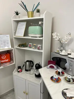 a kitchen with a white counter with a microwave at Guest House Esty in Rome