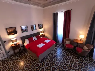 a bedroom with a red bed and a window at Virgilio Suite in Rome