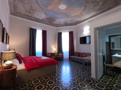 a bedroom with a bed and a living room at Virgilio Suite in Rome