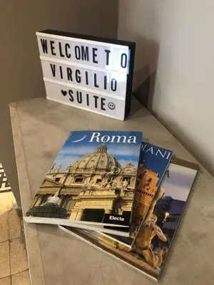 a book sitting on top of a table next to a sign at Virgilio Suite in Rome